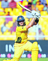 Australia's Shane Watson hits a square drive during their Group A match against Zimbabwe in Ahmedabad on Monday. Watson scored 79.