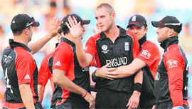 England players congratulate teammate Stuart Broad (C) for taking the wicket of Tom de Grooth in Nagpur on Tuesday.