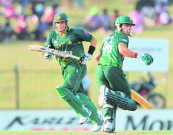 Umar Akmal (R) and Misbah-ul-Haq run between the wickets in Hambantota on Wednesday