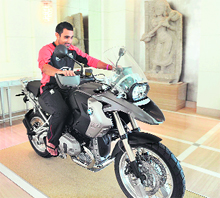Ravi Bopara sits on a luxury motorcycle kept on display at the England team hotel in Bangalore on Thursday
