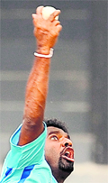 Muttiah Muralitharan delivers the ball during a training session in Colombo on Friday.