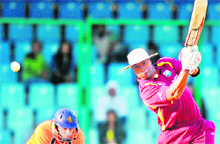 Kieron Pollard (R) plays a shot during the match against the Netherlands at The Feroz Shah Kotla Stadium in New Delhi on Monday. Pollard scored a whirlwind 60. 