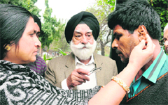 Vasil Khan�s sister shows the scars of alleged police torture on his body on Tuesday.The chairman of the Majha Ex-Servicemen Human Rights Front, Col GS Sandhu (retd), is in the centre