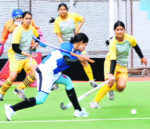 A hockey match in progress between Jalandhar (in blue) and Gurdaspur women teams during the Shaheed-E-Azam Bhagat Singh Punjab Games at Olympian Surjit Hockey stadium in Jalandhar on Tuesday.