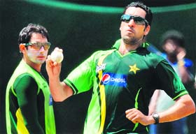 Pakistan�s Umar Gul (R) bowls as teammate Saeed Ajmal looks on during a training session at the R. Premadasa Stadium in Colombo