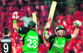Ireland�s Trent Johnston (L) and John Mooney celebrate after scoring the winning runs against England in Bangalore on Wednesday. Ireland won by 3 wickets
