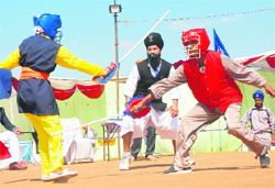 Sarabhjeet (left) from the Barnala team spars with Amanpreet Kaur from the Tarn Taran team during gatka matches in Mohali 