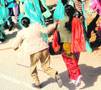 A woman constable drags a protesting health worker at Lambi in Muktsar district on Sunday.