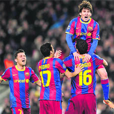Barcelona's Lionel Messi (R-up) is congratulated by teammates after scoring against Arsenal at Camp Nou stadium in Barcelona on Tuesday.
