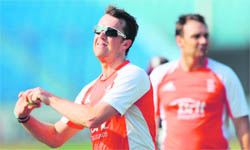 Graeme Swann (L) bowls during a training session in Chittagong on Thursday.
