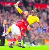 Manchester United�s Wayne Rooney (L) vies with Arsenal�s Bacary Sagna during their FA Cup quarterfinal at Old Trafford in Manchester on Saturday.