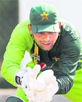 Pakistan's wicket-keeper Kamran Akmal catches a ball during a training session in Pallekele on Saturday. Pakistan will face Zimbabwe in a Group A match on Monday.