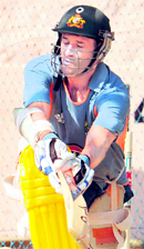 Mike Hussey sweeps in the nets at the M.Chinnaswamy Stadium in Bangalore on Tuesday.