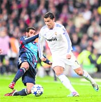Real Madrid�s Cristiano Ronaldo (R) vies with Lyon�s Lisandro in Madrid on Wednesday. � AFP