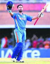 Yuvraj Singh raises his bat to celebrate his century against the West Indies in Chennai on Sunday. India won by 80 runs.