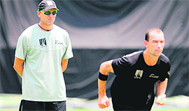 New Zealand bowling coach and former South African fast bowler Allan Donald (L) watches Andy McKay bowl in the nets as the team trains in Colombo on Sunday. New Zealand meet Sri Lanka in the first semifinal on Tuesday.