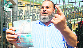 Mohameed Bashir Udeein Khan, a Chicago-based person, shows his passport outside the PCA stadium in Mohali. Khan is among the many cricket lovers without a ticket for the India-Pakistan semifinal.