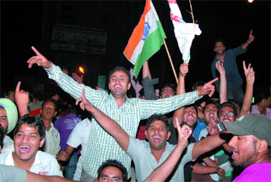 Cricket buffs celebrate after India outplayed Pakistan in the semi-final of the cricket World Cup, near Fire Brigade chowk in Bathinda on Wednesday.