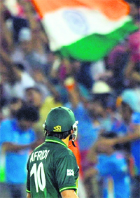 Shahid Afridi walks back to the pavilion after his dismissal in Mohali on Wednesday