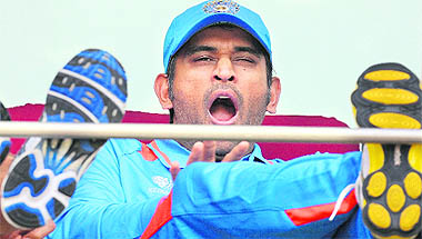 MS Dhoni yawns as he waits for a photo opportunity with the World Cup Trophy at the Wankhede Stadium in Mumbai on Friday.
