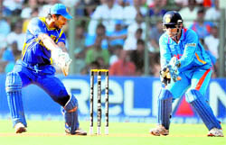 Sri Lankan captain Kumar Sangakkara (L) is caught behind by Mahendra Singh Dhoni during the World Cup final at Wankhede Stadium in Mumbai Saturday. Sri Lanka, guided by Mahela Jayawardene scored 274 after winning the toss and batting first