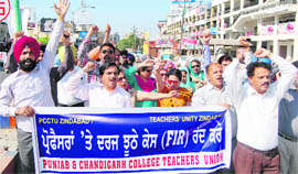 Members of the Punjab and Chandigarh College Teachers Union hold a protest rally on the Lawrence road in Amritsar on Sunday.