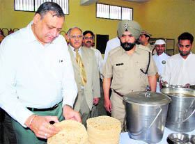 Justice KC Puri checks food at the Ropar jail on Sunday.