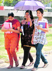 Girls take shelter from heat in Ludhiana on Sunday.