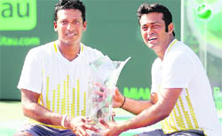 Mahesh Bhupathi (L) and Leander Paes pose with their trophy at the Sony Ericsson Open on Saturday.
