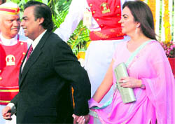 Mukesh Ambani along with wife Nita Ambani at a reception hosted by President Pratibha Patil for the Indian team at the Raj Bhavan in Mumbai on Sunday. 