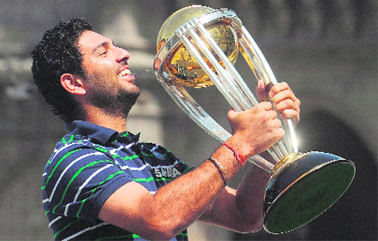 Yuvraj Singh kisses the World Cup trophy at the Taj Mahal hotel in Mumbai on Sunday. Media reports had earlier claimed that the trophy handed out to Team India was a fake and the original was lying with the customs