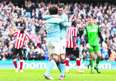David Silva celebrates with Adam Johnson after scoring in Manchester on Sunday. 