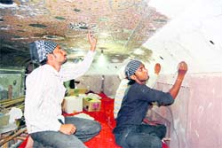 Artists carry out conservation work at Gurdwara Baba Atal in Amritsar.
