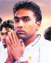 Mahela Jayawardene being blessed by an unseen Buddhist monk on his arrival in Colombo after losing to India in the final in Mumbai. 