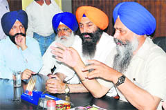 Prem Singh Chandumajra addresses a press conference in Patiala