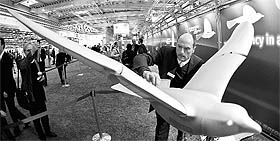An engineer poses with the �SmartBird�, an ultralight model for flight, at the stand of FESTO at the industrial trade fair in Hanover on April 4, 2011.