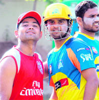 Piyush Chawla (left) of King�s XI and Suresh Raina of Chennai Super Kings at the PCA stadium in Mohali on Tuesday