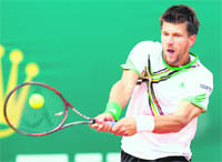 Austria�s Jurgen Melzer hits a return to Switzerland�s Roger Federer during the Monte Carlo ATP Masters Series Tournament in Monaco on Friday.