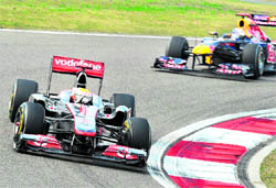 McLaren-Mercedes� Lewis Hamilton (L) is chased by Red Bull-Renault�s Sebastian Vettel during the Formula One Chinese Grand Prix in Shanghai on Sunday. Hamilton won the race