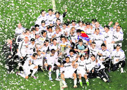 Real Madrid's players celebrate after winning the Spanish Cup final against Barcelona at the Mestalla stadium in Valencia on Wednesday. Real Madrid won 1-0