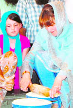 South Australia�s Minister of Multicultural Affairs Grace Portolesi makes a chapati at the Golden Temple on Wednesday