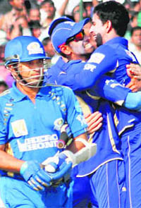 Mumbai Indians� Sachin Tendulkar walks off after being dismissed as Rajasthan Royals� players celebrate in Jaipur on Friday. Rajasthan Royals won the match by seven wickets
