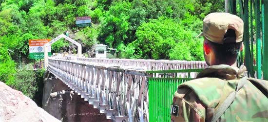 A Pakistani soldier stands guard at the Aman Setu on the LoC at Chakothi in PoK