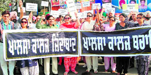Teachers during a rally held to protest the proposed conversion of Khalsa College into a private university, in Amritsar on Sunday