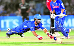 Rajasthan Royals� Ajinkya Rahane dives to avoid being run out against Pune Warriors during their match in Jaipur on Sunday. Rajasthan Royals won by six wickets