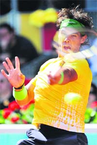 Rafael Nadal hits a return against Marcos Baghdatis during their match at the Caja Magic sports complex in Madrid on Wednesday