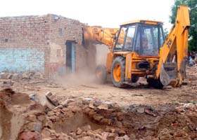 Demolition Drive: A JCB machine removing an encroachment at the grain market in Muktsar on Saturday