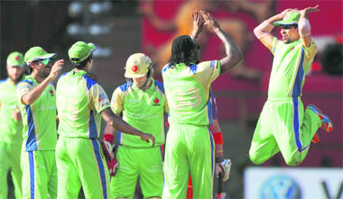 Royal Challengers Bangalore�s Tilakaratne Dilshan jumps in the air as he congratulates Chris Gayle (2ndR) for taking the wicket of Kochi Tuskers Kerala�s Michael Klinger during their match at the M.Chinnaswamy Stadium in Bangalore on Sunday. RCB won the match by 9 wickets.