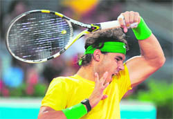 Rafael Nadal hits a return against Roger Federer during their match of the Madrid Masters at the Caja Magic sports complex in Madrid on Saturday.