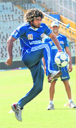 Different Ball Game: Lasith Malinga plays football at the PCA Stadium in Mohali on Monday.